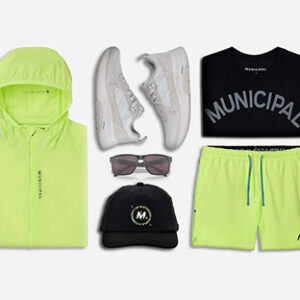 Municipal’s neon jacket and shorts lead this look with M.OG sneakers and Oakley sunglasses